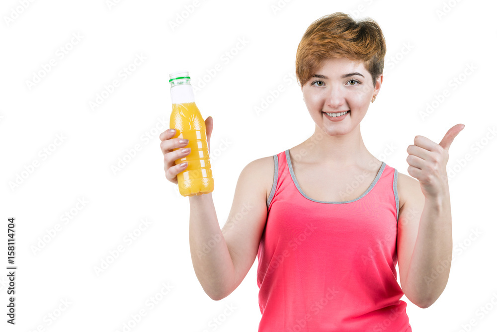 Healthy lifestyle, healthy eating. Young girl with a bottle of orange juice in her hand, smiling with a thumb up, on a white isolated background. Horizontal frame Healthy lifestyle, healthy eating. Young girl with a bottle of orange juice in her hand, smiling with a thumb up, on a white isolated background. Horizontal frame