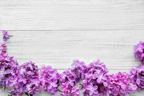 Beautiful lilac flowers on wooden background