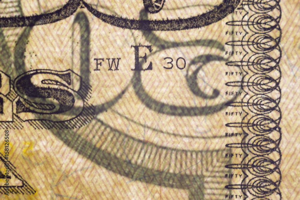 Macro elements on the US fifty dollar bill, selective focus with shallow depth of field. US dollars background.