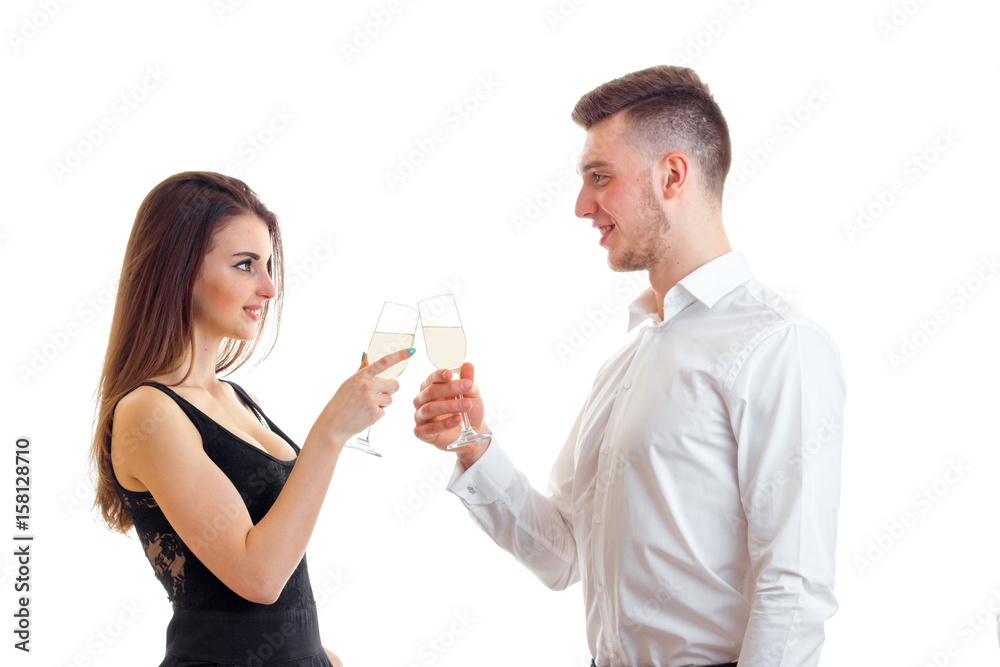 beautiful romantic couple look at each other and holding wine glasses beautiful romantic couple look at each other and holding wine glasses