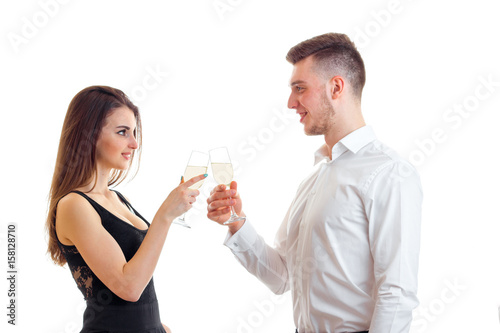 beautiful romantic couple look at each other and holding wine glasses