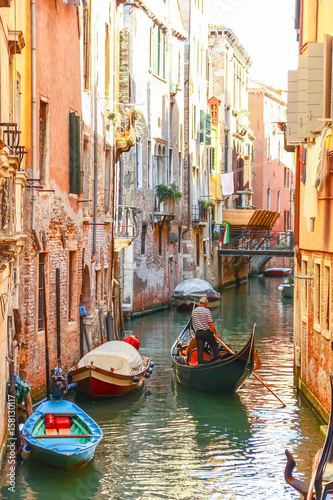 Gondolas sailing in canal, Venice, Italy