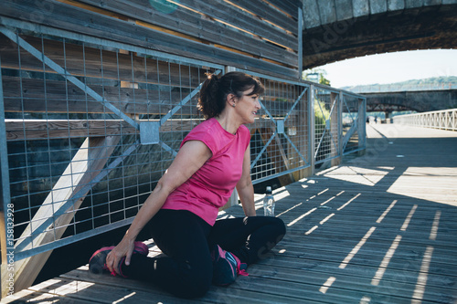 Middle aged woman doing stretching exercises © asife