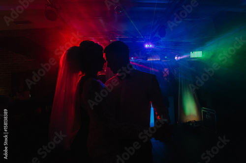 Wedding couple dances in green light