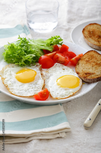 Wallpaper Mural Breakfast - Fried Eggs, bread, tomato and lettuce on a plate Torontodigital.ca
