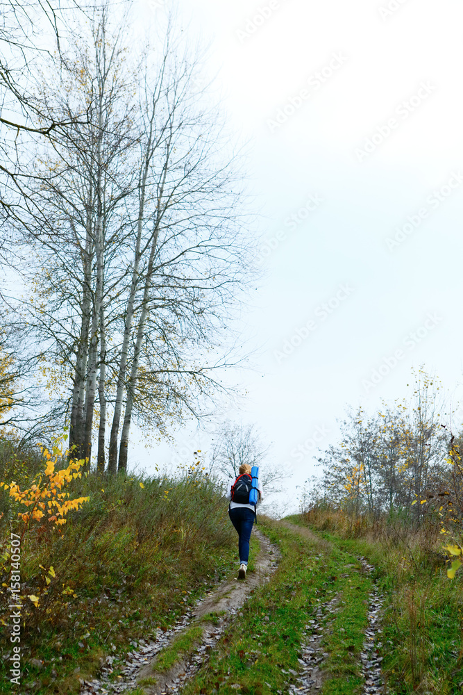 Woman hiker on the autumn nature