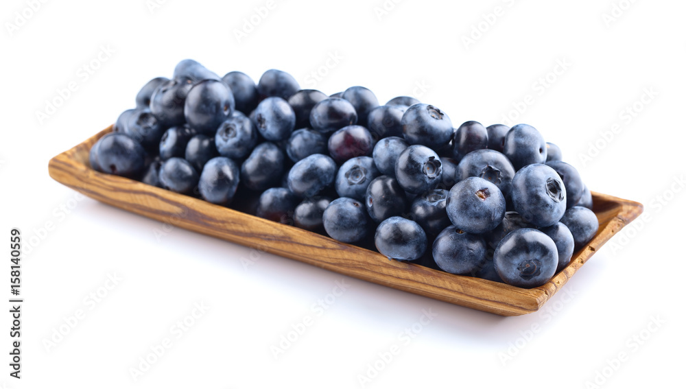 blueberries in wooden dish isolated on white blueberries in wooden dish isolated on white