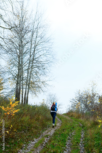 Woman hiker on the autumn nature
