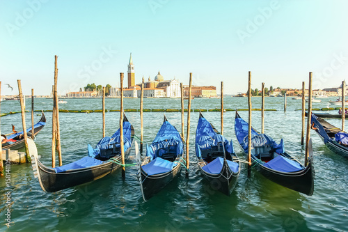 Gondolas moored by Saint Mark square with San Giorgio di Maggiore church in the background, Venice, Italy