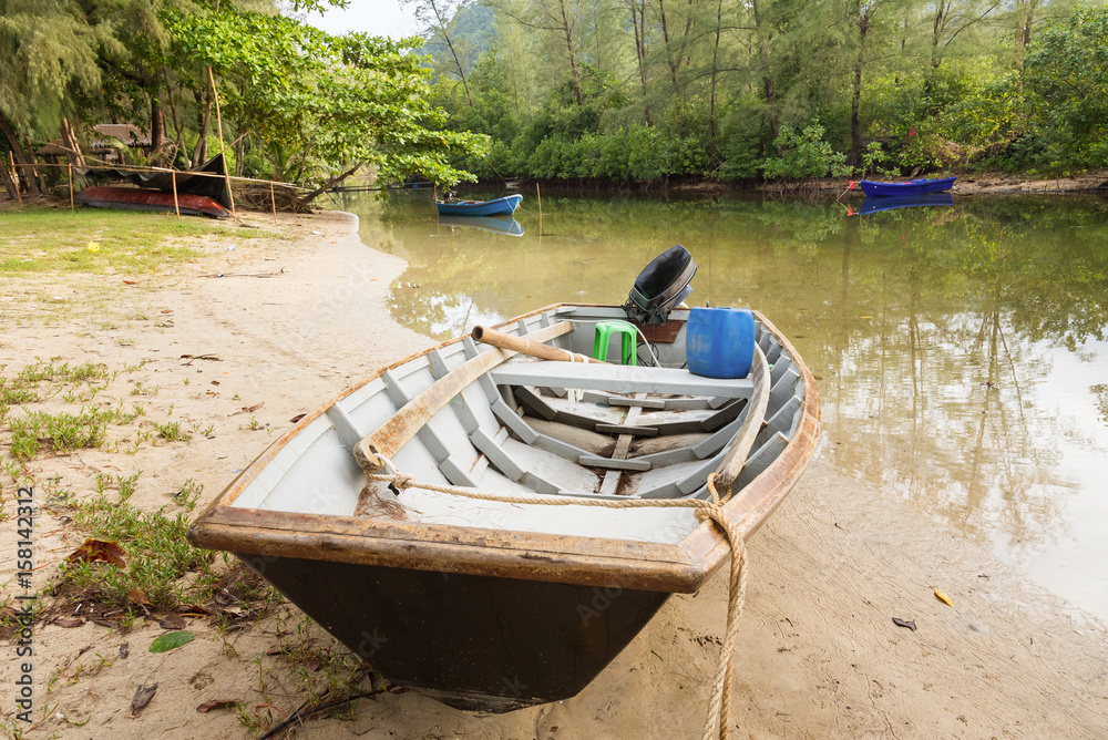 Obraz premium The small boat parked in a small canal at the mangrove forest.Thailand.