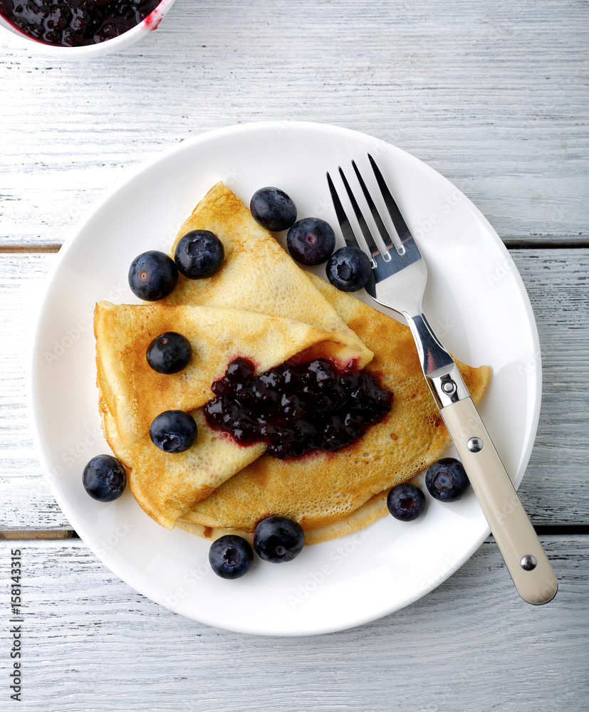 Pancakes on a plate with blueberry jam