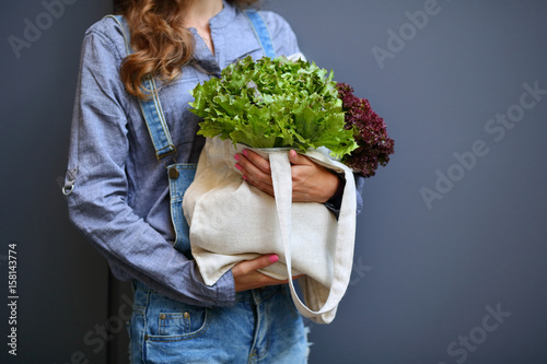 Linen Bag with Lettuce Salad in woman hands