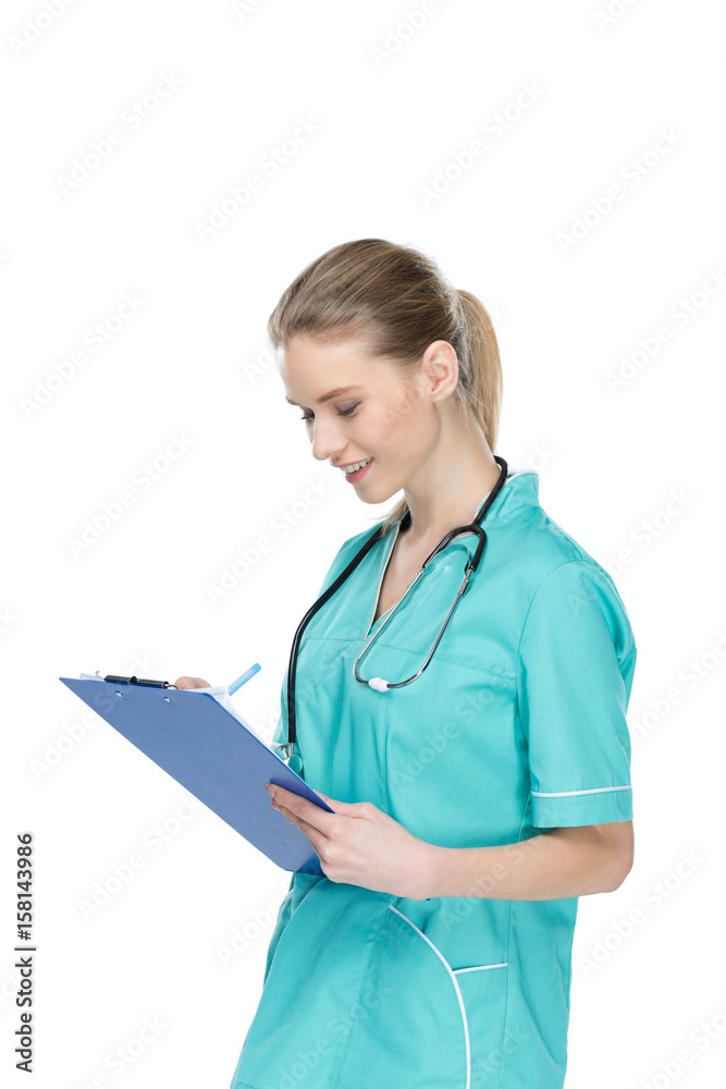 young nurse with stethoscope writing at clipboard isolated on white young nurse with stethoscope writing at clipboard isolated on white