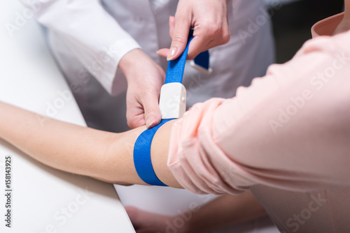 cropped shot of doctor preparing patient to do a blood test
