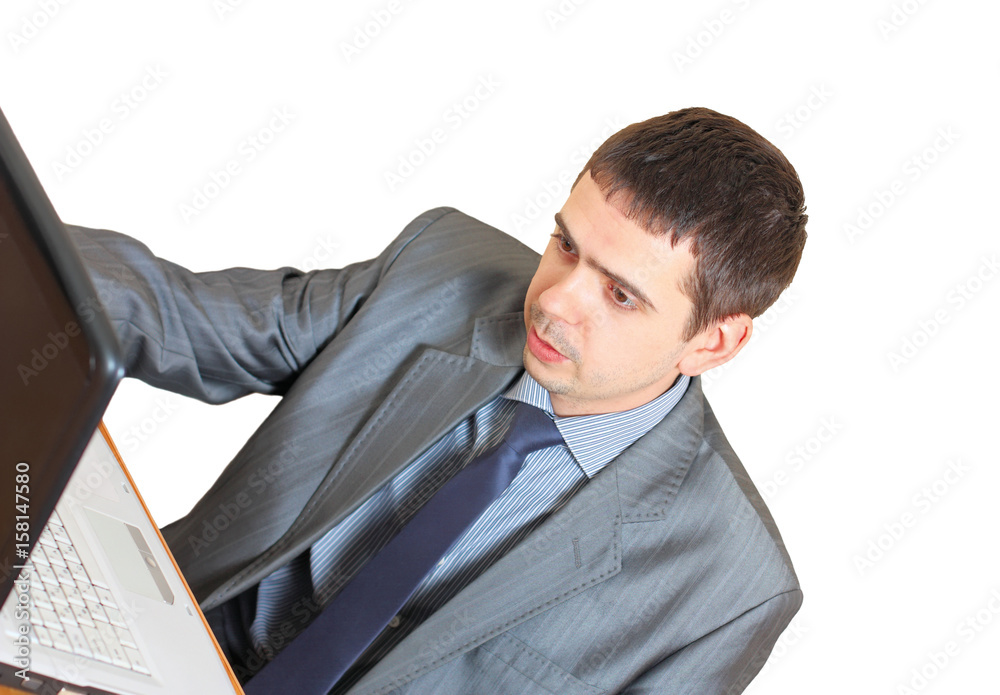 Business man in the workplace with a laptop. Isolated on white background Business man in the workplace with a laptop. Isolated on white background