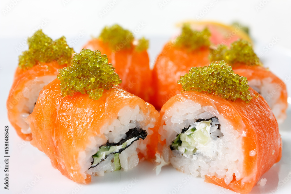 Sushi Roll with salmon, tobiko caviar, wasabi and cucumber Sushi Roll with salmon, tobiko caviar, wasabi and cucumber