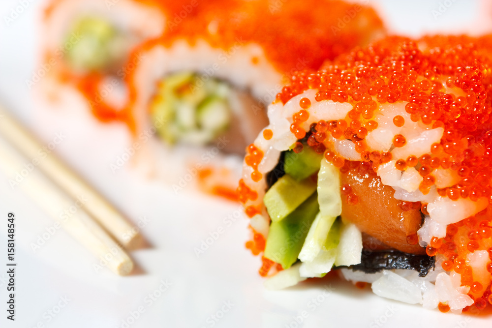 Sushi Roll with tobiko caviar, salmon, avocado and cucumber Sushi Roll with tobiko caviar, salmon, avocado and cucumber