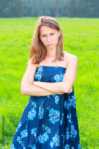 A resentful young woman in blue dress