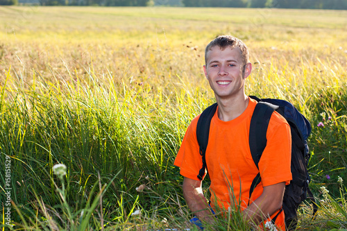 Happy man traveler against a background of green nature