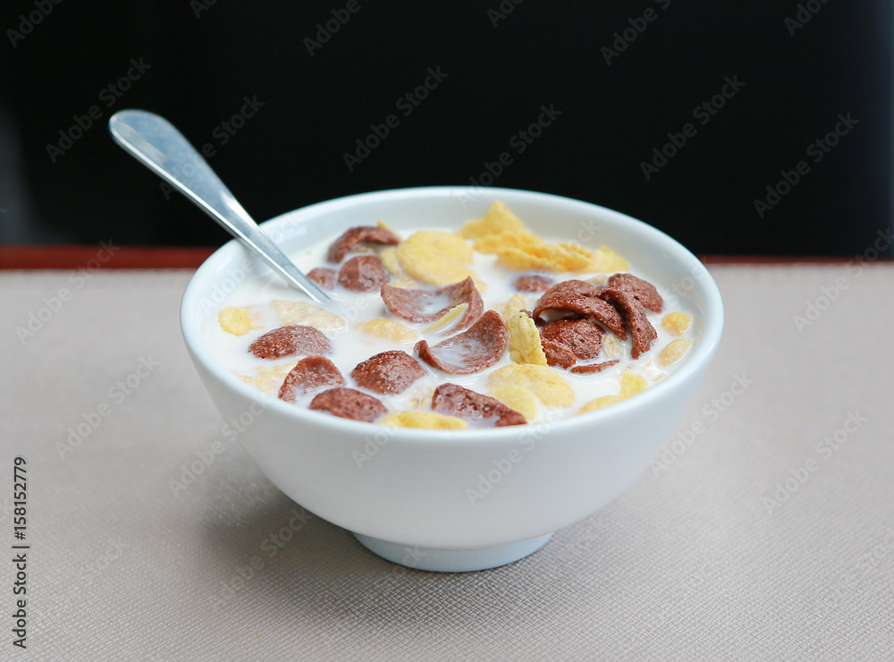 Cornflakes cereal and milk in a bowl. Morning breakfast. Cornflakes cereal and milk in a bowl. Morning breakfast.