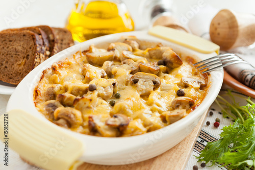 Vegetables casserole with mushrooms, potatoes and cheese closeup