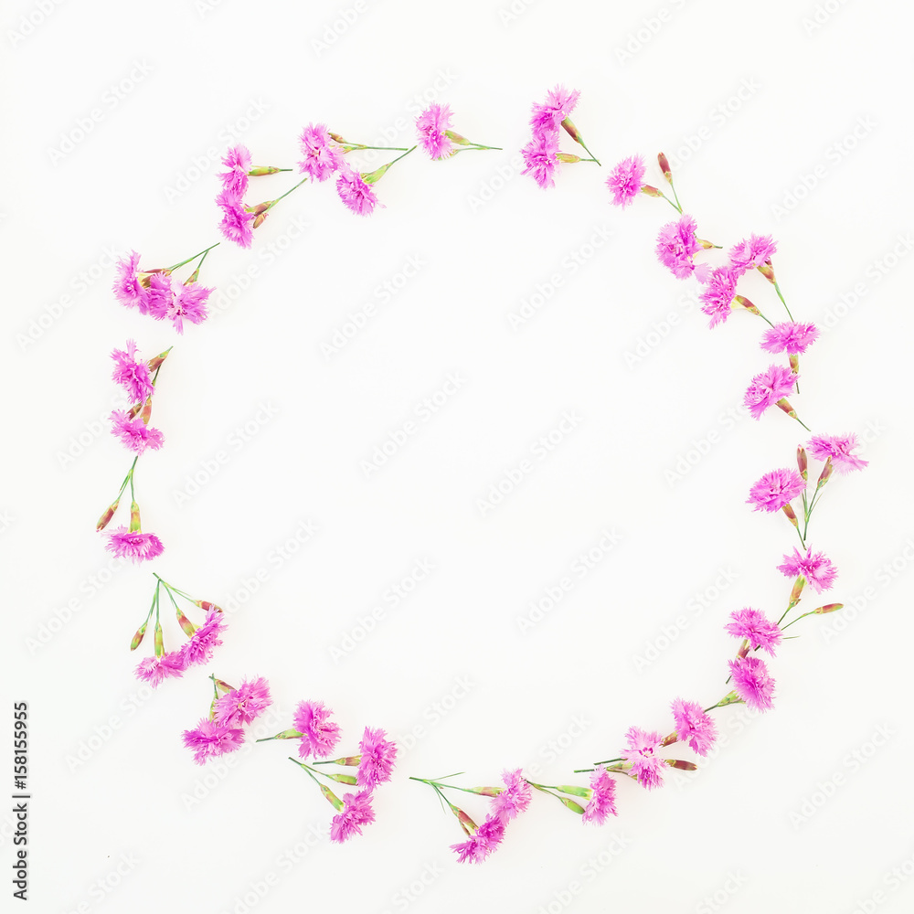 Floral round frame made of pink flowers on white background. Flat lay, top view. Floral pattern