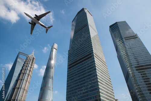 Canvas Print Shanghai skyscrapers buildings and a plane flying overhead at in Shanghai luajiazui finance and business district in morning at Shanghai, China