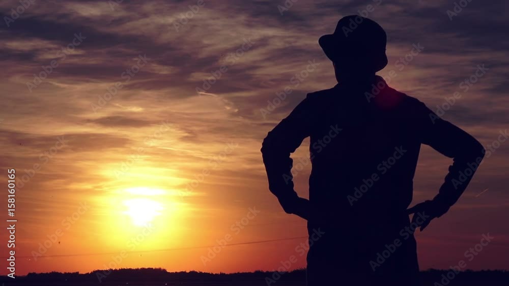 Concerned female agronomist standing in cultivated wheat crops field and looking to a beautiful sunset on the horizon Concerned female agronomist standing in cultivated wheat crops field and looking to a beautiful sunset on the horizon