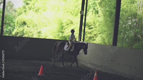 Horse Kids Background in a Horse Racing Competition. Cheerful Little Boy going fast with Running Horse. Horse Training, Young Little Champion. Horse Outdoor Activity for Kids. Riding Horse Background photo