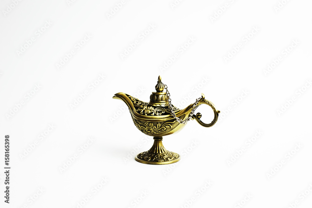 Close up of gold decorated magic lamp isolated in white background. Close up of gold decorated magic lamp isolated in white background.