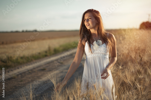 Beautiful woman in wheat meadow © NDABCREATIVITY