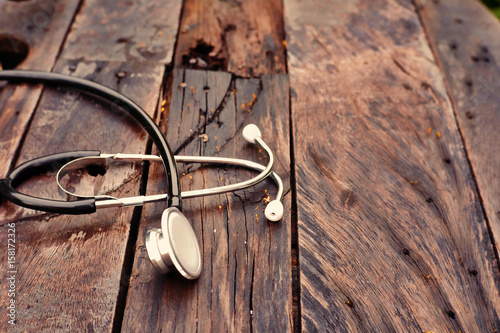 Close up stethoscope on wooden background.