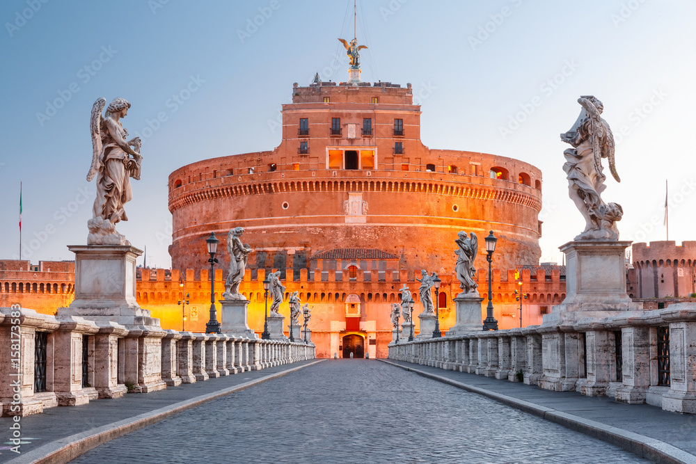 Naklejka premium Saint Angel castle and bridge and Saint Peter Cathedral during morning blue hour in Rome, Italy.