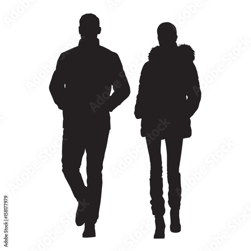 Man and wife are dressed in winter clothes. Walking people, young couple. Vector silhouettes