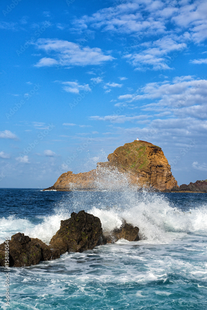 lighthouse and rock in porto moniz in madeira