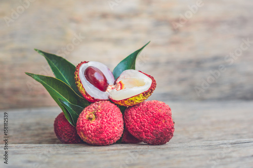 Fresh litchi fruit on an old wooden background photo