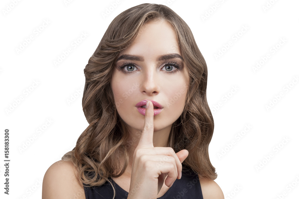 Woman with wavy hair making hush sign isolated Woman with wavy hair making hush sign isolated