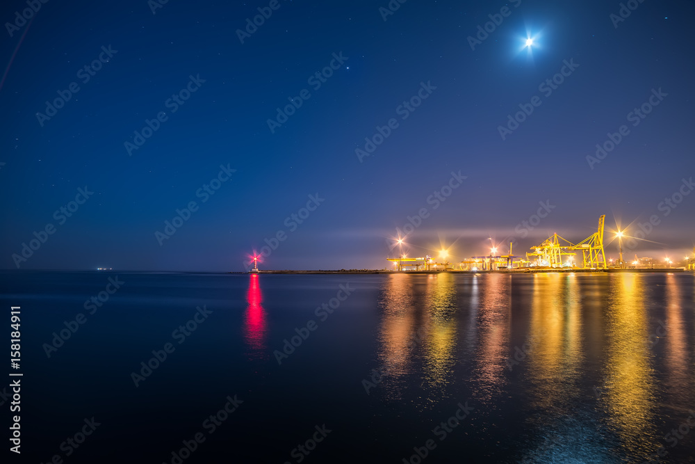 A view of the port facilities, a small lighthouse at the entrance to the port. Night photo.
A view of the port facilities, a small lighthouse at the entrance to the port. Night photo.