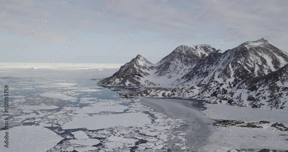 areal shot of mystic mountains and sea in Greenland areal shot of mystic mountains and sea in Greenland