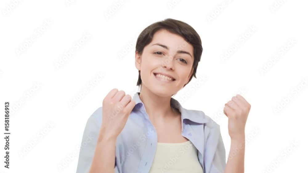 Happy beautiful female with short brunette hair rejoicing and saying yes over white background Happy beautiful female with short brunette hair rejoicing and saying yes over white background