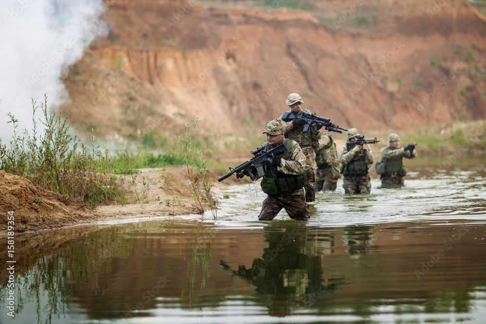 special forces soldiers with weapon take part in military maneuver. war, army, technology and people concept.