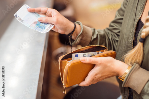 Woman paying with cash at bar photo