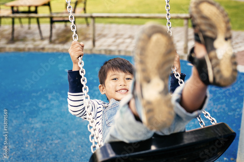 Boy (4-5) on swing