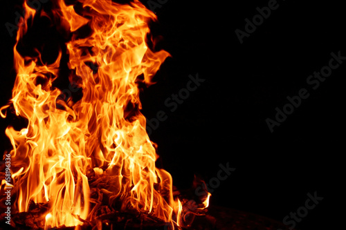 Fire flame. Bonfire background with bright vivid flame on black background.