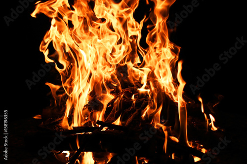 Fire flame. Bonfire background with bright vivid flame on black background.