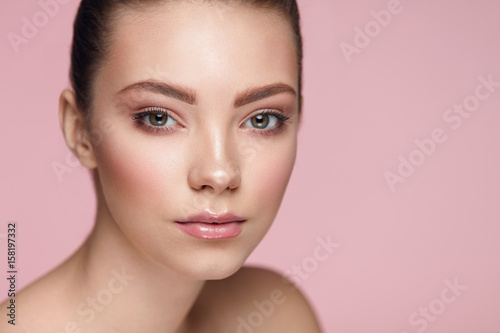 Facial Beauty Makeup. Woman With Fresh Face On Pink Background