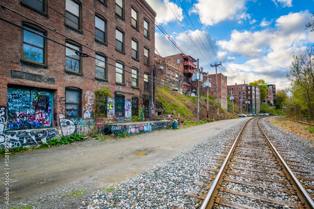 Fototapeta premium Railroad tracks and old buildings in Brattleboro, Vermont.