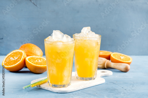 Glass of orange juice with ice cubes Cold orange fresh Glass of orange juice for hot summer day Copy space