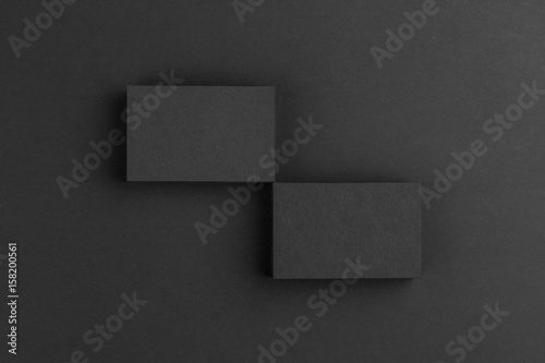 Black business cards isolated on black background