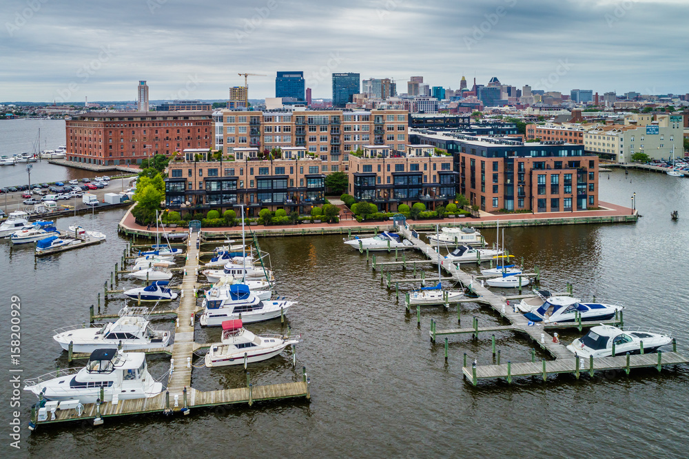 View of a marina and buildings on the waterfront of Fell's Point, in Baltimore, Maryland.